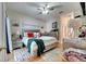 Comfortable bedroom with a ceiling fan, neutral walls, and an ensuite bathroom at 603 Pinehurst Ct, Kissimmee, FL 34758