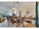 The dining room features an decorative chandelier, seating for six, and ample natural light at 603 Pinehurst Ct, Kissimmee, FL 34758