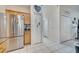 Kitchen with stainless steel refrigerator and extra storage adjacent to hallway at 603 Pinehurst Ct, Kissimmee, FL 34758