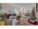Bright and open living area with hardwood floors, ample seating, and a view of the entry at 603 Pinehurst Ct, Kissimmee, FL 34758