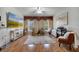 Sunlit living room with hardwood floors, neutral colors, and large windows at 603 Pinehurst Ct, Kissimmee, FL 34758
