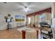 Bright living room featuring hardwood floors and large TV at 603 Pinehurst Ct, Kissimmee, FL 34758