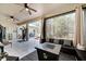 Spacious screened patio offering an outdoor entertaining space, fitness equipment, and access to the backyard at 603 Pinehurst Ct, Kissimmee, FL 34758