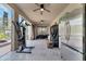 Large screened patio featuring exercise equipment, an extra fridge, and ample space for outdoor activities at 603 Pinehurst Ct, Kissimmee, FL 34758