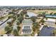 An aerial view of community shuffleboard courts, bocce ball courts, lake and a golf course at 2378 Ridgeway Ct, The Villages, FL 32162