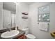 Bathroom showcasing a sink, toilet, and decorative shelves at 2378 Ridgeway Ct, The Villages, FL 32162