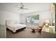 Bright bedroom features a ceiling fan and a sunny window at 2378 Ridgeway Ct, The Villages, FL 32162