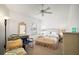 Bedroom features a ceiling fan, woven furniture, and ample space at 2378 Ridgeway Ct, The Villages, FL 32162