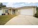 Charming single-story home featuring a well-manicured lawn and an attached two-car garage at 2378 Ridgeway Ct, The Villages, FL 32162