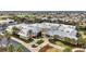 Aerial view of community clubhouse with palm trees, an American flag, and colorful architecture at 2378 Ridgeway Ct, The Villages, FL 32162