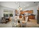 Open-concept kitchen and dining area featuring a glass-top table and stylish seating, perfect for gatherings at 2378 Ridgeway Ct, The Villages, FL 32162
