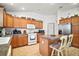Bright kitchen featuring stainless steel appliances, kitchen island with seating and ample cabinet space at 2378 Ridgeway Ct, The Villages, FL 32162
