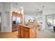 Inviting kitchen with stainless steel refrigerator, kitchen island with seating, seamlessly connected to the living area at 2378 Ridgeway Ct, The Villages, FL 32162