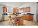 Well-lit kitchen with central island, modern appliances, tiled floor and ample cabinet space for storage at 2378 Ridgeway Ct, The Villages, FL 32162