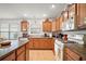 Well-lit kitchen features tile flooring, wood cabinetry, and modern appliances at 2378 Ridgeway Ct, The Villages, FL 32162