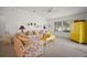 Bright living room features floral couches, yellow accents, and a cozy atmosphere with natural light at 2378 Ridgeway Ct, The Villages, FL 32162