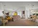 Bright living room with vaulted ceilings, comfortable floral furniture and a charming dining area at 2378 Ridgeway Ct, The Villages, FL 32162