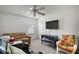 Living room with ceiling fan, sofa, and white wicker chair at 2378 Ridgeway Ct, The Villages, FL 32162