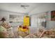 Bright living room with vaulted ceilings, comfortable floral furniture and a yellow accent cabinet at 2378 Ridgeway Ct, The Villages, FL 32162