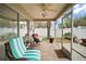 Cozy screened porch featuring stylish furniture, ceiling fan and tiled floor offering a relaxing outdoor space at 2378 Ridgeway Ct, The Villages, FL 32162
