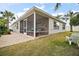 Enclosed lanai featuring a tiled patio and views of the private backyard at 2378 Ridgeway Ct, The Villages, FL 32162