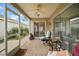 A relaxing screened-in porch with ceiling fan and tiled floors offers a comfortable outdoor living area at 2378 Ridgeway Ct, The Villages, FL 32162