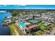 Aerial view showcasing community amenities: pool, tennis courts, clubhouse, and waterfront access at 9000 Us Highway 192 # 242, Clermont, FL 34714