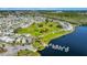 Scenic aerial perspective of the community golf course bordered by homes and a serene lake at 9000 Us Highway 192 # 242, Clermont, FL 34714