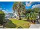 Enjoy the spacious backyard with lush green grass and a mature palm tree perfect for relaxation at 9000 Us Highway 192 # 242, Clermont, FL 34714