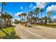 Scenic entrance to Outdoor Resorts 9000, lined with swaying palm trees and beautiful landscaping at 9000 Us Highway 192 # 242, Clermont, FL 34714