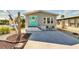 Charming single-story home featuring a vibrant turquoise front door and a well-manicured front yard with ample parking at 9000 Us Highway 192 # 242, Clermont, FL 34714