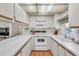 Clean and bright kitchen featuring white cabinets, a microwave, and a view into the living area at 9000 Us Highway 192 # 242, Clermont, FL 34714