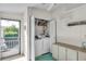 Convenient laundry area featuring a washer, dryer, built-in shelves, and easy outdoor access at 9000 Us Highway 192 # 242, Clermont, FL 34714