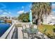 Enjoy outdoor dining on the patio with a table, chairs, and a charming view of the canal at 9000 Us Highway 192 # 242, Clermont, FL 34714