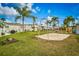Community playground featuring swings and a sandy area surrounded by green grass and a vibrant neighborhood setting at 9000 Us Highway 192 # 242, Clermont, FL 34714