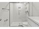 Modern bathroom with walk-in shower and white vanity at 103 S Flagler Ave, Edgewater, FL 32132