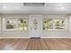 Entryway with wood-look flooring, lots of light from the surrounding windows, and an elegant door at 103 S Flagler Ave, Edgewater, FL 32132