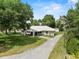 Charming home with a long driveway and lush greenery all around the property at 103 S Flagler Ave, Edgewater, FL 32132