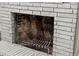 White brick fireplace with metal grate at 103 S Flagler Ave, Edgewater, FL 32132
