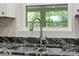 Updated kitchen featuring sink with stainless steel faucet and granite countertops at 103 S Flagler Ave, Edgewater, FL 32132
