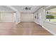 Open-concept living area with wood-look flooring, and neutral-colored walls at 103 S Flagler Ave, Edgewater, FL 32132