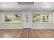 Living room featuring wood floors and a decorative front door at 103 S Flagler Ave, Edgewater, FL 32132
