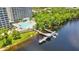 Beautiful aerial view featuring a large pool, dock, and lake offering scenic waterfront living at 13427 Blue Heron Beach Dr # 2106, Orlando, FL 32821