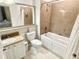 Well-lit bathroom featuring a shower-tub combo, granite countertop vanity, and neutral tile floors at 13427 Blue Heron Beach Dr # 2106, Orlando, FL 32821
