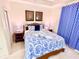 Cozy bedroom featuring a comfortable queen bed, stylish decor, and ample natural light at 13427 Blue Heron Beach Dr # 2106, Orlando, FL 32821