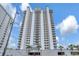 Low angle view of the condo building featuring multiple levels of balconies and an underground parking garage at 13427 Blue Heron Beach Dr # 2106, Orlando, FL 32821