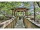 Wooden gazebo surrounded by lush greenery, offering a tranquil escape with nature views at 13427 Blue Heron Beach Dr # 2106, Orlando, FL 32821