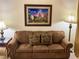 Cozy living room with a comfortable sofa, lamps, and Disney-themed artwork at 13427 Blue Heron Beach Dr # 2106, Orlando, FL 32821