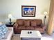 Cozy living room with a comfortable sofa, lamps, and Disney-themed artwork at 13427 Blue Heron Beach Dr # 2106, Orlando, FL 32821