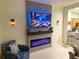 Modern living room features a fireplace, mounted TV, and tile flooring at 13427 Blue Heron Beach Dr # 2106, Orlando, FL 32821